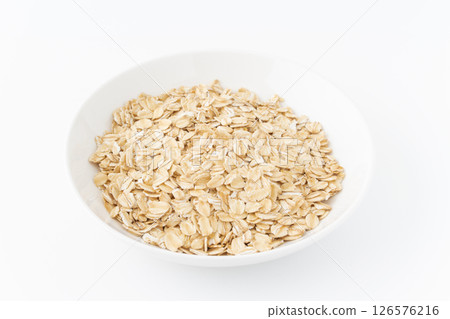 Oatmeal (rolled oats) on a plate on a white background 126576216