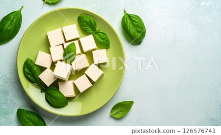 A festive green gift box with a red ribbon and gold bow, perfect for Christmas, holidays, or any special celebration 126576741