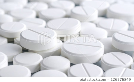 Colorful and red-and-white medicine pills and capsules are isolated on a white background, representing health and pharmaceutical care 126576849
