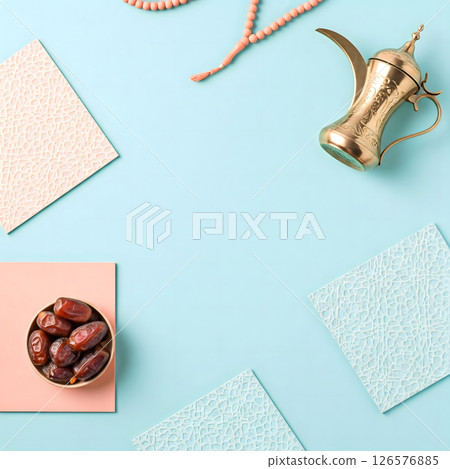 Dates, prayer beads, and a dallah are arranged on a blue background with textured accents. A cultural still life Dates, prayer beads, and a dallah are arranged on a blue background with textured accents. A cultural still life 126576885