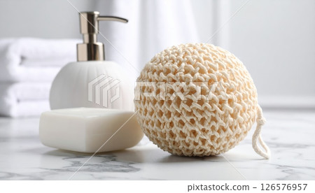 White isolated plastic dispenser bottles with soap, bath salt, and a towel for clean body care and spa hygiene 126576957