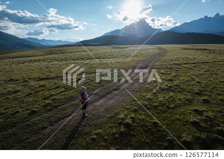 Aerial view of woman trail runner in high altitude mountains 126577114
