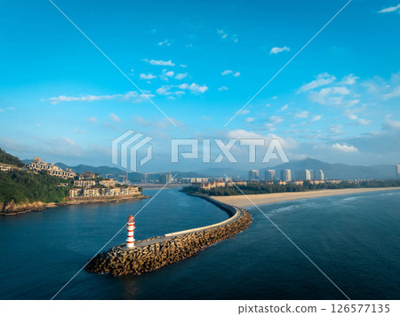 Aerial view of red and white striped lighthouse on seaside Aerial view of red and white striped lighthouse on seaside 126577135