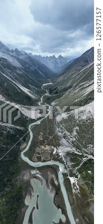Aerial view of beautiful high altitude forest canyon and snow capped mountain landscape 126577157