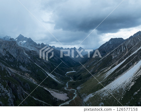 Aerial view of beautiful high altitude forest canyon and snow capped mountain landscape Aerial view of beautiful high altitude forest canyon and snow capped mountain landscape 126577158