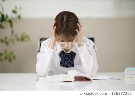 School girl who is studying 126577295