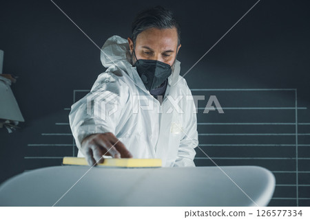 Shaper working on surf board Shaper working on surf board 126577334