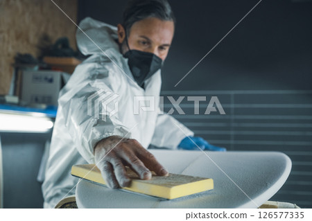 Shaper working on surf board 126577335