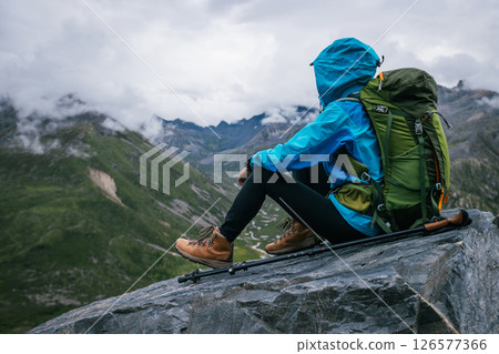 Hiking woman enjoy the view on high altitude mountain top 126577366