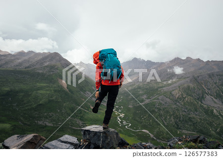 Hiking woman on high altitude mountain top 126577383