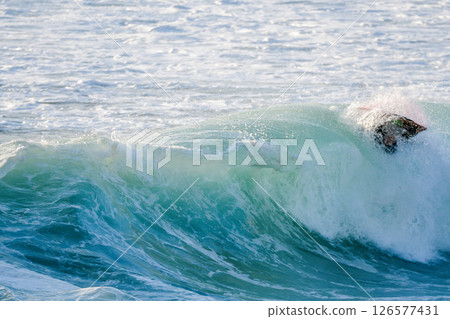 Bodyboarder surfing ocean wave Bodyboarder surfing ocean wave 126577431