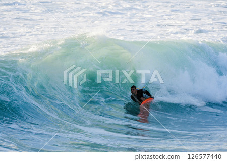 Bodyboarder surfing ocean wave Bodyboarder surfing ocean wave 126577440