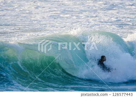 Bodyboarder surfing ocean wave Bodyboarder surfing ocean wave 126577443