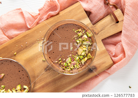Top view of chocolate mousses with pistachios 126577783