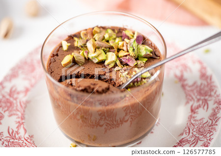 Close-up of chocolate mousse with pistachios and spoon Close-up of chocolate mousse with pistachios and spoon 126577785