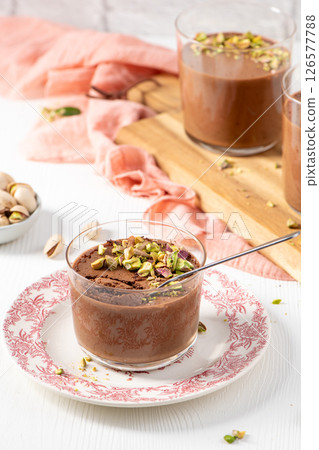 Delicious chocolate mousse topped with pistachios in glasses 126577788