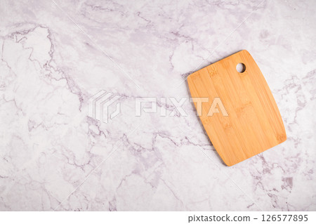 Wooden cutting board on a gray marble background 126577895