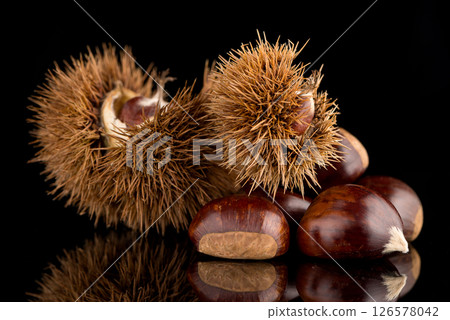 Chestnuts on a black reflective background 126578042
