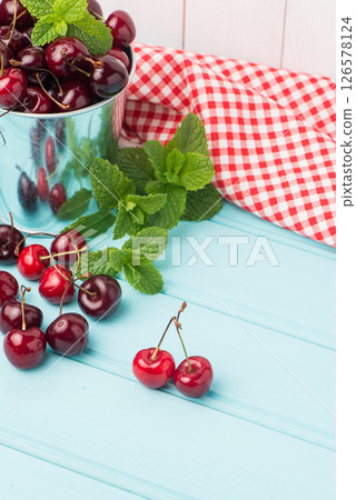 Cherries in blue wooden table 126578124