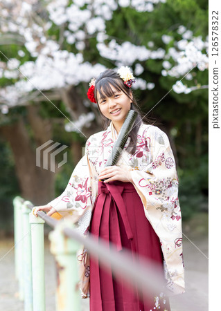 A girl in a hakama holding a certificate at an elementary school graduation ceremony A girl in a hakama holding a certificate at an elementary school graduation ceremony 126578322