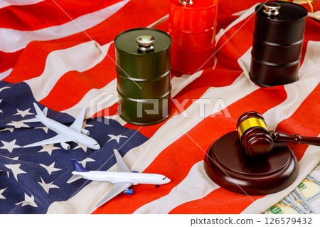 Miniature airplanes Judicial gavel positioned on striped flag, blending themes of law, travel 126579432