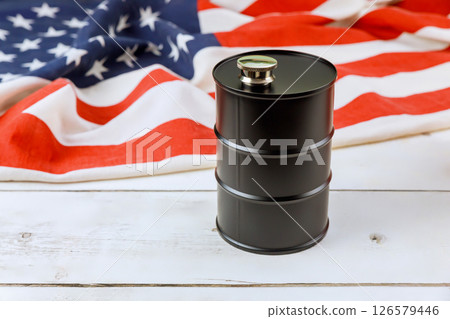 Oil barrel positioned on folded American flag, representing energy national pride 126579446
