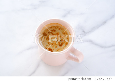 Image of a person relaxing while drinking a cafe latte, a coffee made from espresso and milk Image of a person relaxing while drinking a cafe latte, a coffee made from espresso and milk 126579552