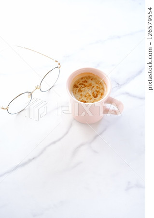 Image of a person relaxing while drinking a cafe latte, a coffee made from espresso and milk Image of a person relaxing while drinking a cafe latte, a coffee made from espresso and milk 126579554