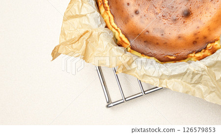 Delicious Cheesecake With caramel Crust And Creamy Filling Baked To Perfection standing on baking rack 126579853