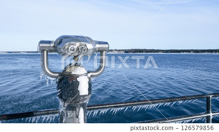 Frozen View Through a Public Telescope Sights Overlooking Icy Lake Frozen View Through a Public Telescope Sights Overlooking Icy Lake 126579856
