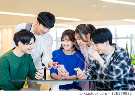 College students looking at their smartphones. Photo courtesy of Denpa Gakuen, Tokyo Electronics College. College students looking at their smartphones. Photo courtesy of Denpa Gakuen, Tokyo Electronics College. 126579922