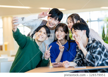 Friendly university students taking a photo. Photo courtesy of Denpa Gakuen, Tokyo Electronics College. 126579951