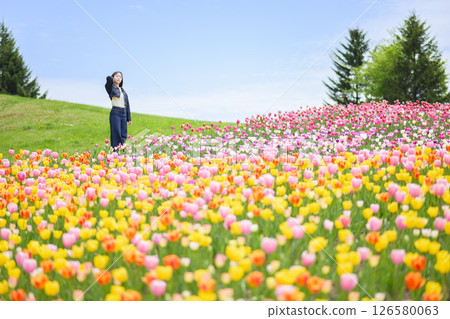 A young woman sightseeing in a tulip field 126580063