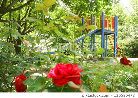 公園裡樹木和花壇環繞的滑梯 公園裡樹木和花壇環繞的滑梯 126580478