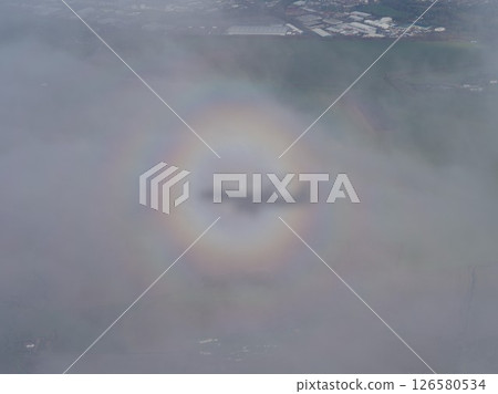 Rainbow is seen in the sky above a city 126580534