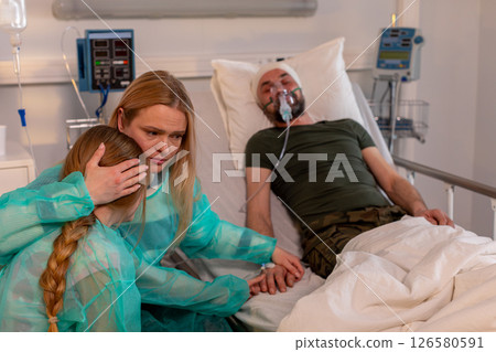 An emotional hospital scene highlights the crucial support and care from family in tough times An emotional hospital scene highlights the crucial support and care from family in tough times 126580591