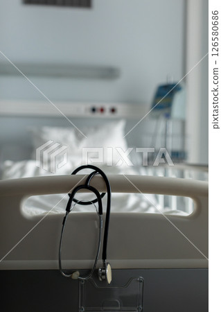 A Hospital Scene featuring a Stethoscope and a Patient Bed within a Medical Setting 126580686