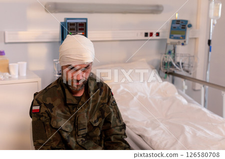 A brave injured soldier is currently recovering in a hospital room after a fierce battle 126580708