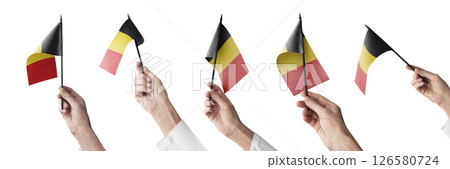 The Belgium flag in hand in different angles on a white background The Belgium flag in hand in different angles on a white background 126580724