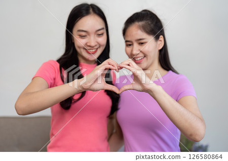 Loving couple celebrating their bond with a heart gesture during moving 126580864