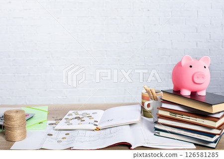 Effective Financial Planning Utilizing Books and a Piggy Bank for a Secure Future 126581285