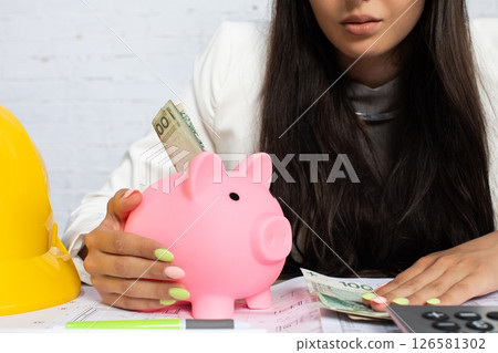 Comprehensive Financial Planning with a Charming Pink Piggy Bank and Currency Cash 126581302