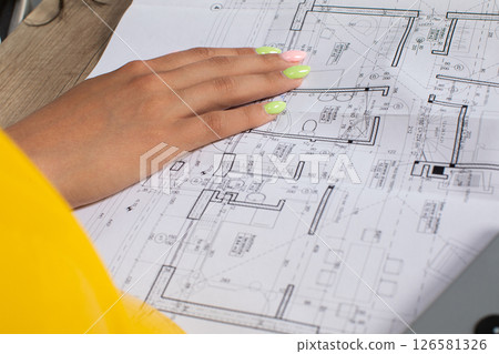 An Extensive and Detailed Architectural Blueprint Accompanied by Hand Review Process 126581326