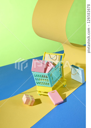 Grocery carts roll paper lanes filled with packages, symbolizing smooth online transactions and order fulfillment routes. The yellow, blue, and green color scheme blends harmoniously. 126581678