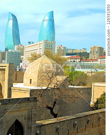 Baku city, Azerbaijan, view of historic mosques and walls of the Shirvanshahs Palace in the Old City and modern glass Flame Towers Baku city, Azerbaijan, view of historic mosques and walls of the Shirvanshahs Palace in the Old City and modern glass Flame Towers 126581950