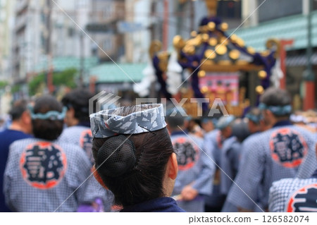 A portable shrine and a woman wearing a hawk-headed hat at the Sanja Festival 126582074