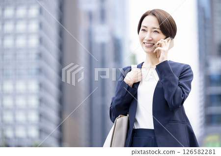 Business, smartphone, middle-aged woman talking 126582281