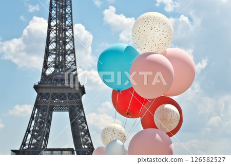 Eiffel Tower and colorful balloons under blue sky Eiffel Tower and colorful balloons under blue sky 126582527