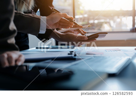 Accounting company provide finance and taxation planning for profitable cash flow, Auditor and accountant team working in office, analyze financial data and accounting record with calculator.Insight 126582593