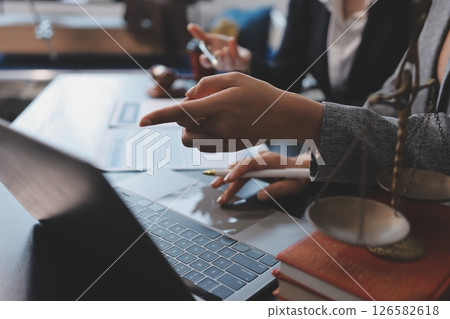 Judge gavel with Justice lawyers having team meeting at law firm background. Concepts of Law and Legal services. 126582618